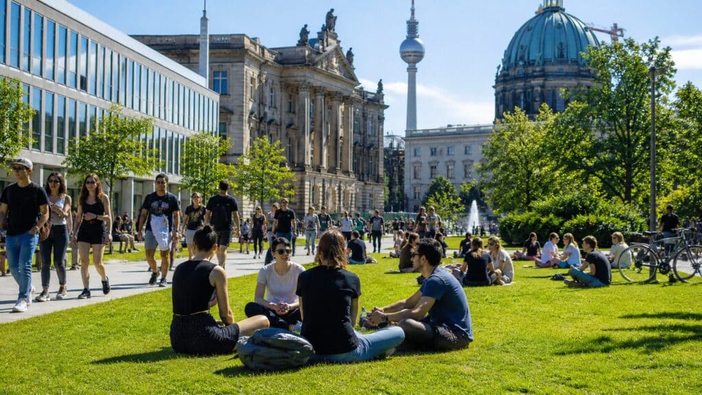 International students relaxing and socializing on a university campus in Berlin, showing student life in Germany